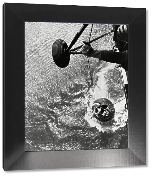 Shepard hoisted from Mercury capsule, 1961. Creator: NASA