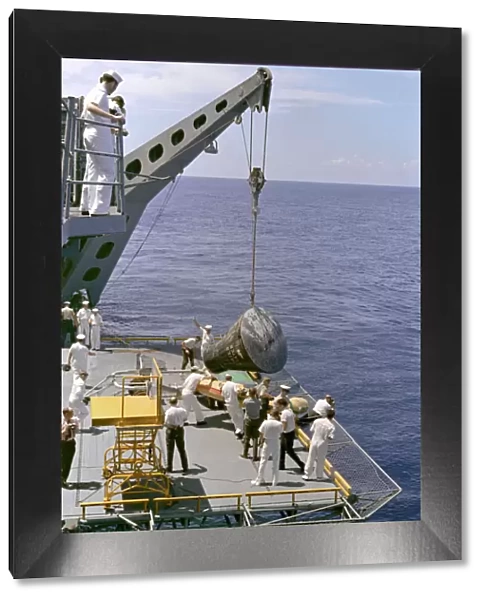 Gemini 5 capsule hoisted onboard recovery ship, 1965. Creator: NASA