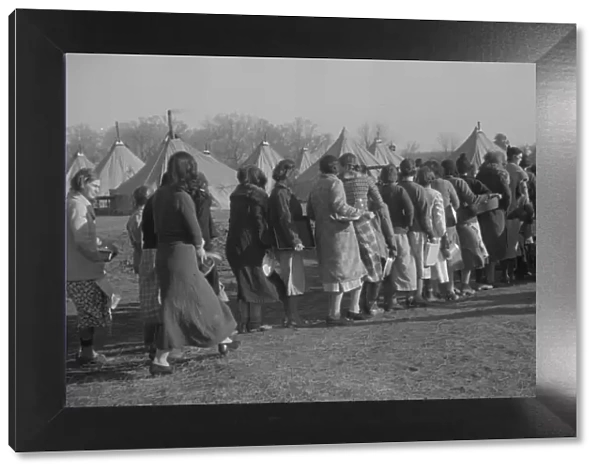 Refugees lined up at meal time in the camp for white flood refugees in Forest City, Arkansas, 1937. Creator: Walker Evans
