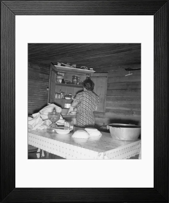 Framed Print : Wife of tobacco sharecropper putting breakfast dishes away. Person County, North Carolina, 1939. Creator: Dorothea Lange Framed Print : Wife of tobacco sharecropper putting breakfast dishes away. Person County, North Carolina, 1939. Creator: Dorothea Lange