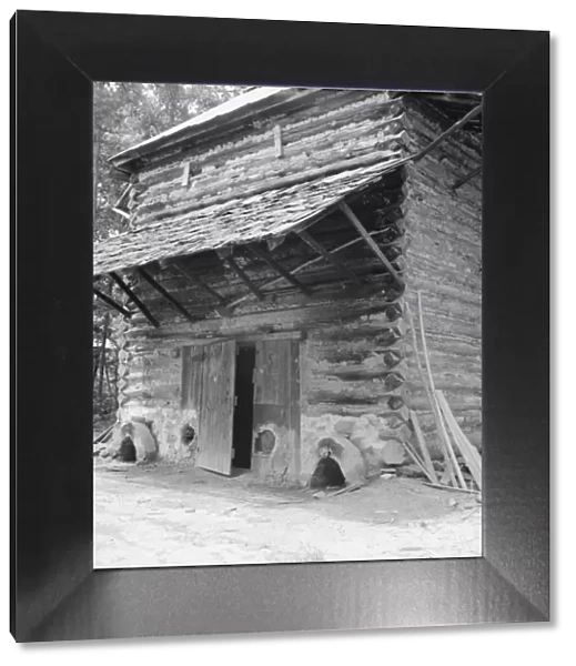 Tobacco barn with newly plastered furnace... Person County, North Carolina, 1939. Creator: Dorothea Lange