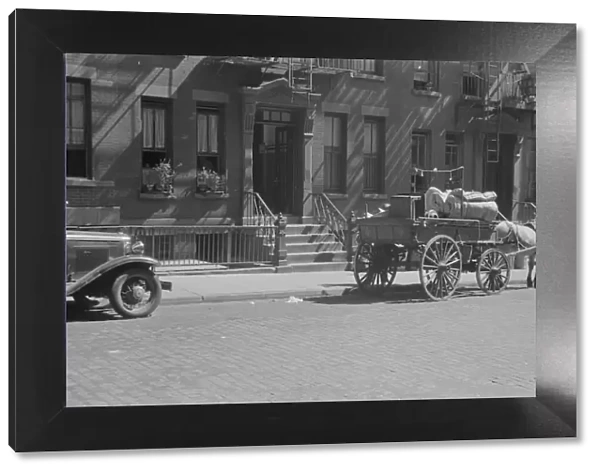 A tenant is moving on horse-drawn wagon, 61st Street between 1st and 3rd Avenues, New York, 1938. Creator: Walker Evans