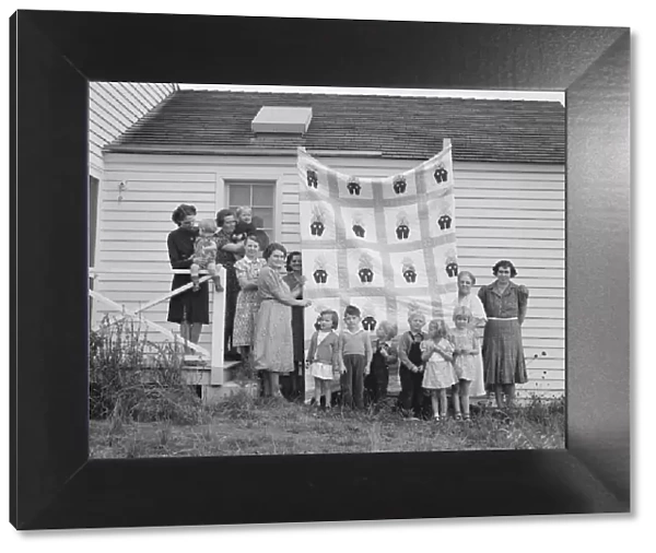 Farm women of the 'Helping Hand'club display a pieced quilt... near West Carlton, Oregon, 1939. Creator: Dorothea Lange