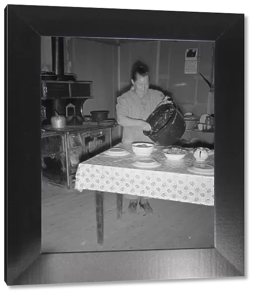Mrs. Wardlow getting dinner after church in her basement... Dead Ox Flat, Oregon, 1939. Creator: Dorothea Lange