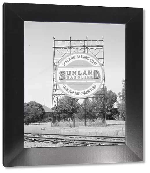 Illuminated sign, approaching San Joaquin Valley town, outskirts of Fresno, on U. S. 99, CA, 1939. Creator: Dorothea Lange