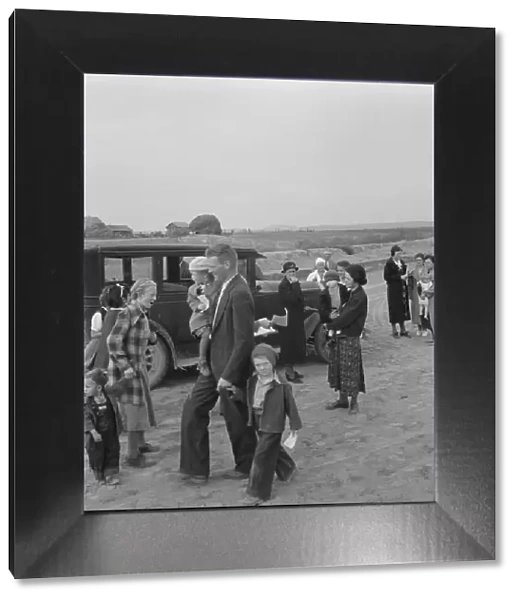 Congregation leaving after services, preacher in doorway, Dead Ox Flat, Oregon, 1939. Creator: Dorothea Lange