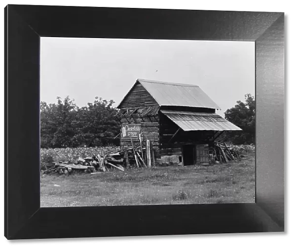 The tobacco barn, a distinctive American architectural form, Person County, North Carolina, 1939. Creator: Dorothea Lange