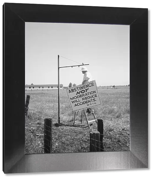 Member of the committee... erects sign on U.S. 99 highway, near Hanford, California, 1939. Creator: Dorothea Lange