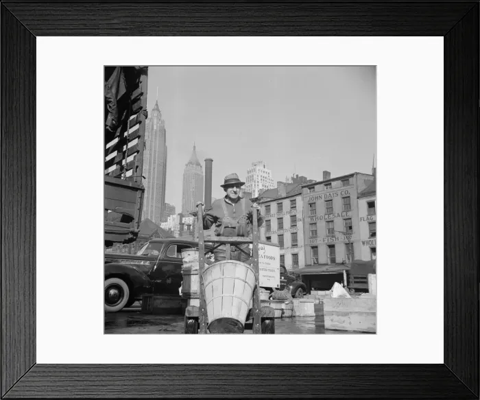 Framed Print : Stevedore who packs and loads crates of fish on the lower east side, 1943. Creator: Gordon Parks