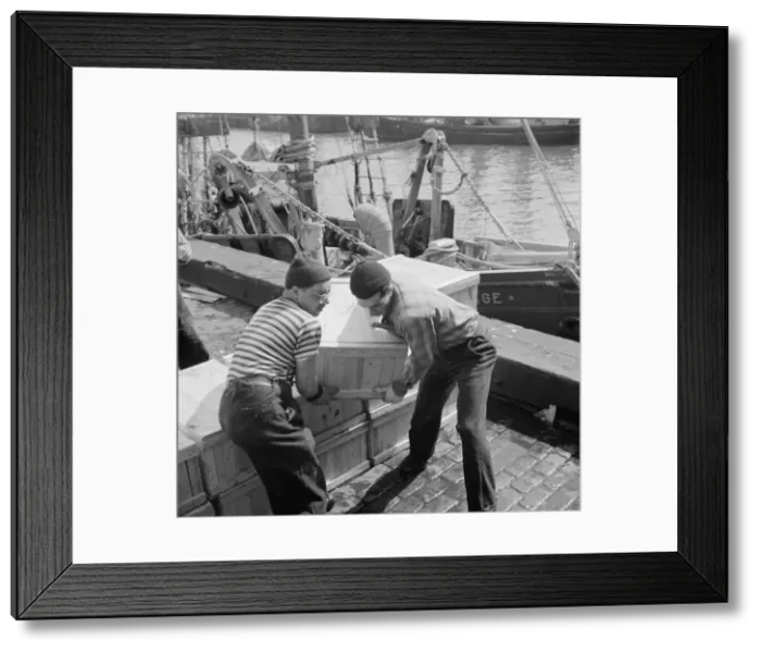 Framed Print : Loaders placing fish that has been taken from boats, boxed, and iced, aboard... New York, 1943. Creator: Gordon Parks Framed Print : Loaders placing fish that has been taken from boats, boxed, and iced, aboard... New York, 1943. Creator: Gordon Parks