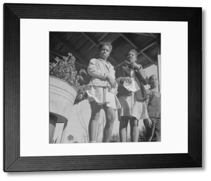 Framed Print : Two sisters with their brother on the front porch of the family home, Daytona Beach, Florida, 1943. Creator: Gordon Parks Framed Print : Two sisters with their brother on the front porch of the family home, Daytona Beach, Florida, 1943. Creator: Gordon Parks