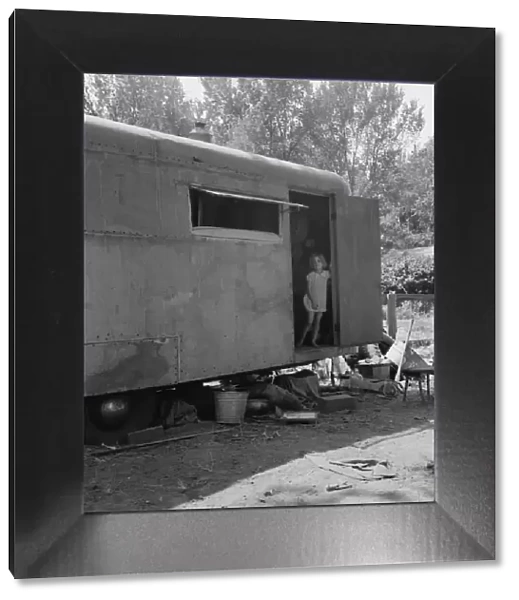 The house trailer and the youngest little girl, Washington, Yakima Valley, Toppenish, 1939. Creator: Dorothea Lange