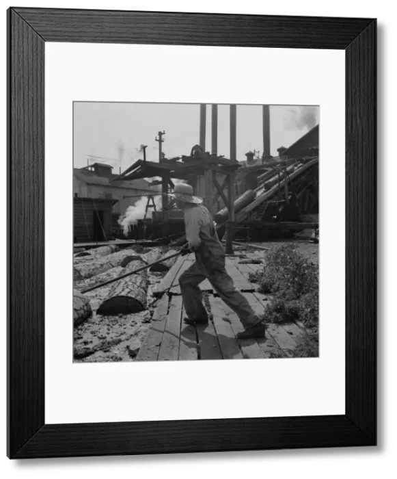 Framed Print : Pond monkey guides... Pelican Bay Lumber Company mill, Klamath Falls, Oregon, 1939. Creator: Dorothea Lange Framed Print : Pond monkey guides... Pelican Bay Lumber Company mill, Klamath Falls, Oregon, 1939. Creator: Dorothea Lange