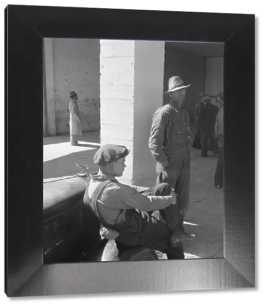 Pea pickers waiting at FSA office for issue of surplus commodities, Calipatria, California, 1939. Creator: Dorothea Lange