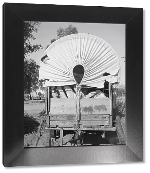 Covered wagon, migratory carrot pullers camp, near Holtville, Imperial Valley, 1939. Creator: Dorothea Lange
