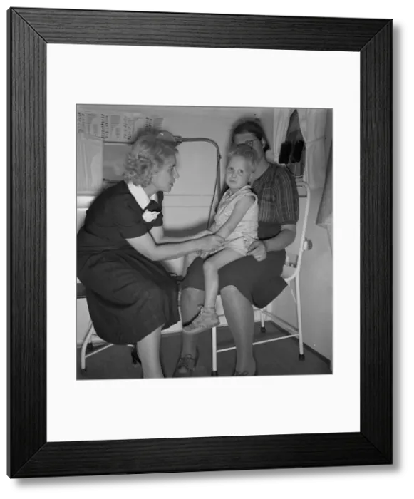 Framed Print : In trailer clinic, the nurse consults the migrant... Merrill FSA camp, Klamath County, Oregon, 1939 Creator: Dorothea Lange Framed Print : In trailer clinic, the nurse consults the migrant... Merrill FSA camp, Klamath County, Oregon, 1939 Creator: Dorothea Lange