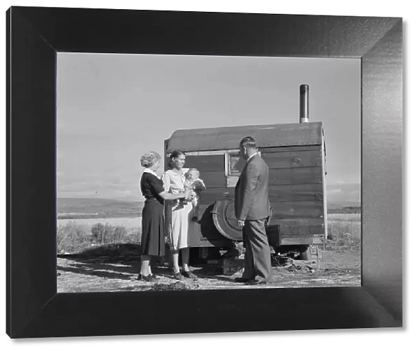 The doctor reassures the mother... the sick baby, Merrill, Klamath County, Oregon, 1939. Creator: Dorothea Lange