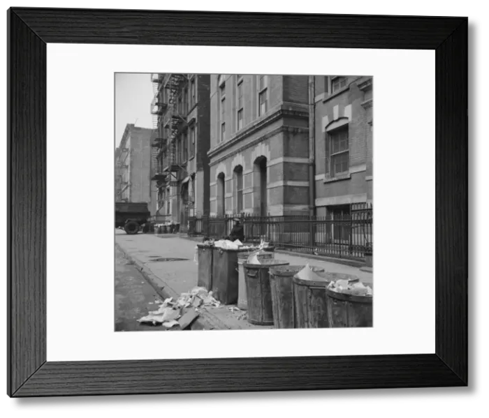 Framed Print : Street scene showing open trash cans along the curb, New York, 1943. Creator: Gordon Parks Framed Print : Street scene showing open trash cans along the curb, New York, 1943. Creator: Gordon Parks