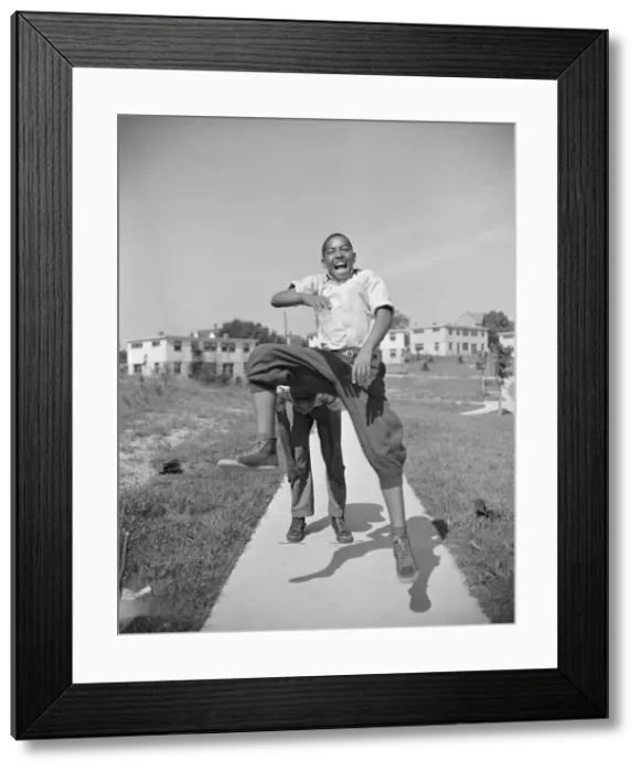 Framed Print : Boys playing leap frog near the project, Frederick Douglass housing project, Anacostia, D. C. 1942. Creator: Gordon Parks Framed Print : Boys playing leap frog near the project, Frederick Douglass housing project, Anacostia, D. C. 1942. Creator: Gordon Parks