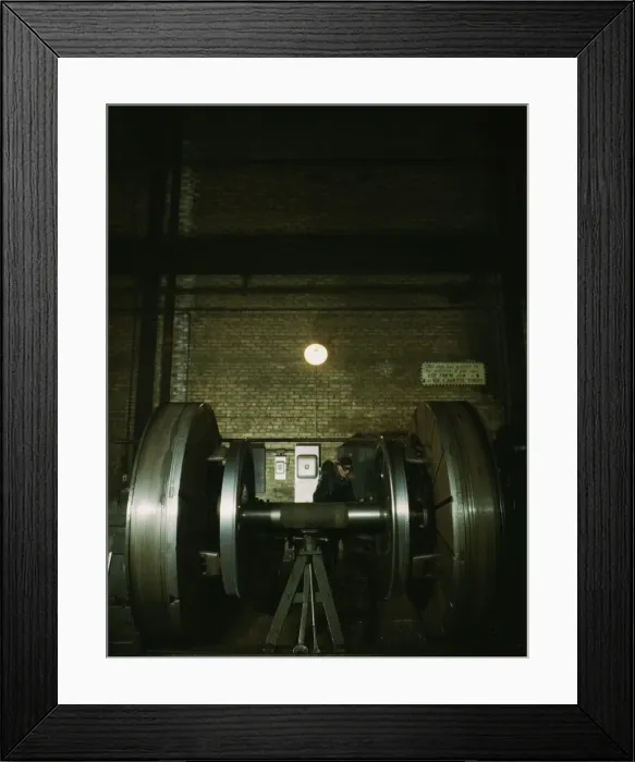 Framed Print : Worn tires on locomotive wheels are refaced on this machine in the wheel shop... Chicago, 1942. Creator: Jack Delano Framed Print : Worn tires on locomotive wheels are refaced on this machine in the wheel shop... Chicago, 1942. Creator: Jack Delano