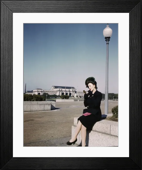 Framed Print : Woman putting on her lipstick in a park with Union Station behind her, Washington, D. C. ca. 1943. Creator: Unknown Framed Print : Woman putting on her lipstick in a park with Union Station behind her, Washington, D. C. ca. 1943. Creator: Unknown