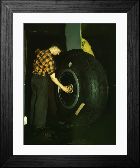 Framed Print : Inspecting of landing wheel of the transport planes at Willow Run, between 1941 and 1945. Creator: Howard Hollem Framed Print : Inspecting of landing wheel of the transport planes at Willow Run, between 1941 and 1945. Creator: Howard Hollem