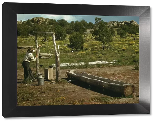 Faro Caudill drawing water from his well, Pie Town, New Mexico, 1940. Creator: Russell Lee