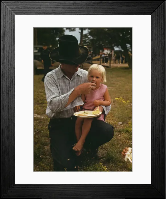 Framed Print : Homesteader feeding his daughter at the Pie Town, New Mexico Fair free barbeque, 1940. Creator: Russell Lee Framed Print : Homesteader feeding his daughter at the Pie Town, New Mexico Fair free barbeque, 1940. Creator: Russell Lee