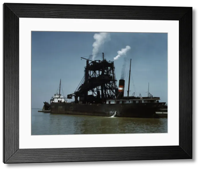 Framed Print : Loading coal into a freighter at one of the Pennsylvania Railroad docks, Sandusky, Ohio, 1943. Creator: Jack Delano Framed Print : Loading coal into a freighter at one of the Pennsylvania Railroad docks, Sandusky, Ohio, 1943. Creator: Jack Delano