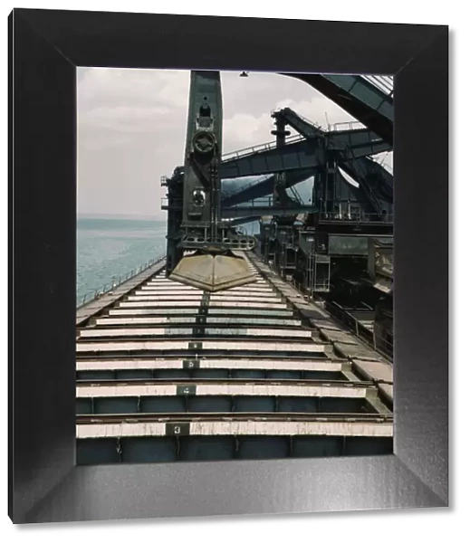 Pennsylvania R.R. iron ore docks, unloading ore from a lake freighter... ore unloaders, 1943. Creator: Jack Delano