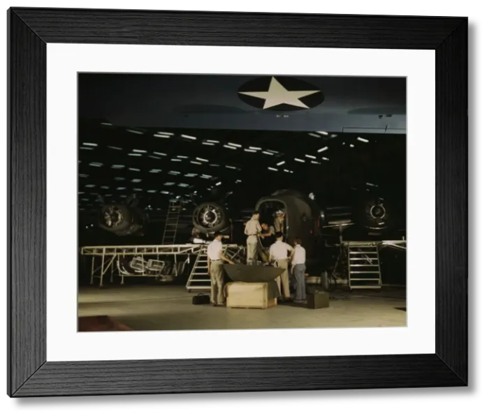 Framed Print : Getting a nose door ready to put on a C-87... Consolidated Aircraft Corp... Fort Worth, Texas, 1942. Creator: Howard Hollem Framed Print : Getting a nose door ready to put on a C-87... Consolidated Aircraft Corp... Fort Worth, Texas, 1942. Creator: Howard Hollem
