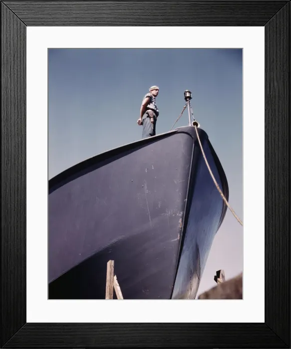 Framed Print : A Coast Guard sentry stands watch over a new torpedo boat under construction at a southern... 1942. Creator: Howard Hollem Framed Print : A Coast Guard sentry stands watch over a new torpedo boat under construction at a southern... 1942. Creator: Howard Hollem
