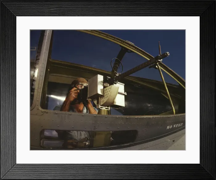 Framed Print : Jesse Rhodes Waller, A.O.M. third class, tries out a 30-calibre... Naval Air Base, Corpus... 1942. Creator: Howard Hollem