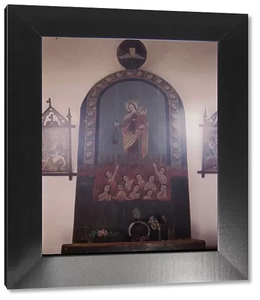 The altar of Nuestra Senora del Carmel on the south wall of the church, Trampas, N. M. 1943. Creator: John Collier