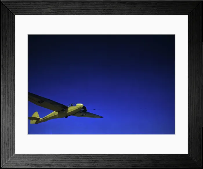 Framed Print : A Marine Corps glider being towed by a power plane from Page Field, at Parris Island, S. C. 1942. Creator: Alfred T Palmer Framed Print : A Marine Corps glider being towed by a power plane from Page Field, at Parris Island, S. C. 1942. Creator: Alfred T Palmer