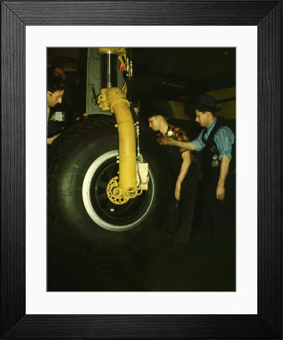 Framed Print : Inspecting of landing wheel of the transport planes at Willow Run, between 1941 and 1945. Creator: Howard Hollem Framed Print : Inspecting of landing wheel of the transport planes at Willow Run, between 1941 and 1945. Creator: Howard Hollem