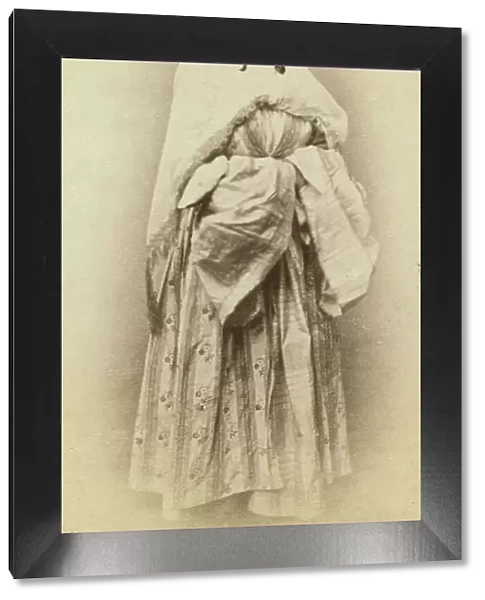 Full-length portrait of a woman, facing slightly right, in traditional dress, between 1870 and 1886. Creator: Unknown