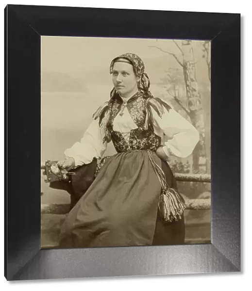 A young woman poses in a folk costume, 1890-1920. Creator: Helene Edlund