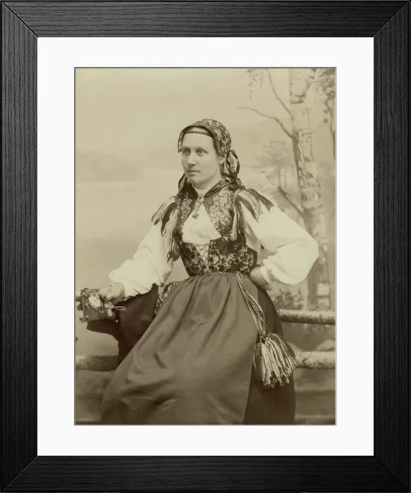 Framed Print : A young woman poses in a folk costume, 1890-1920. Creator: Helene Edlund