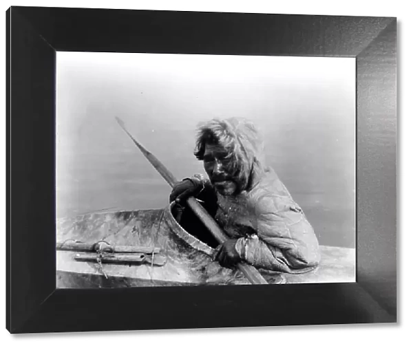 The seal-hunter, Noatak, in kayak, facing left, c1929. Creator: Edward Sheriff Curtis