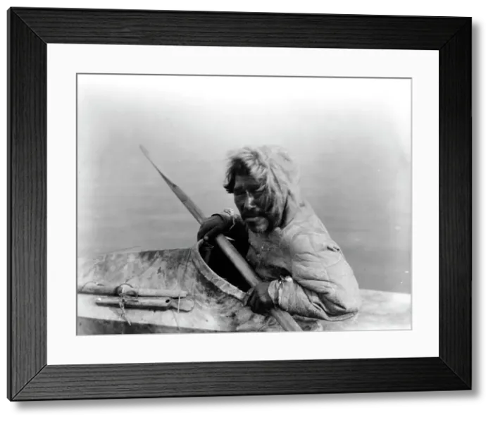 Framed Print : The seal-hunter, Noatak, in kayak, facing left, c1929. Creator: Edward Sheriff Curtis