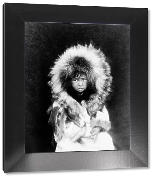 Noatak child, three-quarter length portrait, seated, facing front, c1929. Creator: Edward Sheriff Curtis