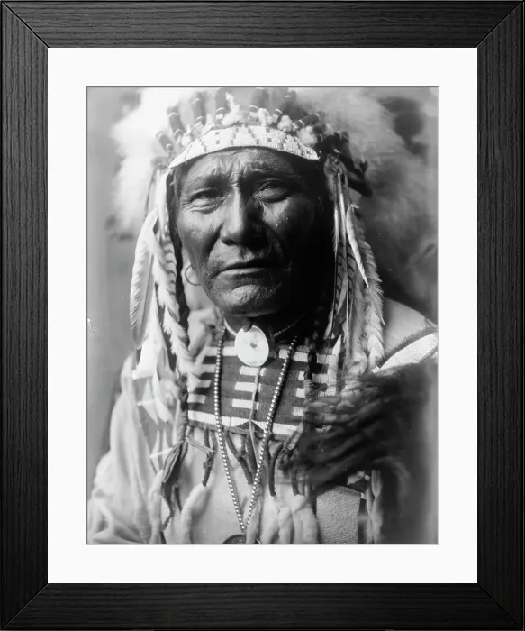 Framed Print : Ghost Bear, Crow Indian, Montana, head-and-shoulders portrait, facing front, feather... c1908. Creator: Edward Sheriff Curtis Framed Print : Ghost Bear, Crow Indian, Montana, head-and-shoulders portrait, facing front, feather... c1908. Creator: Edward Sheriff Curtis
