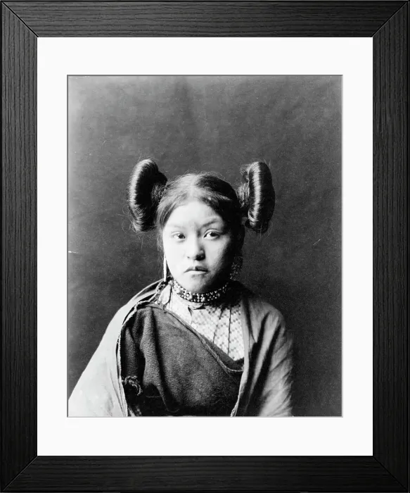 Framed Print : Gobuguoy, Walpi girl, half-length portrait, facing front, hair tied in swirls on sides of... c1900. Creator: Edward Sheriff Curtis Framed Print : Gobuguoy, Walpi girl, half-length portrait, facing front, hair tied in swirls on sides of... c1900. Creator: Edward Sheriff Curtis