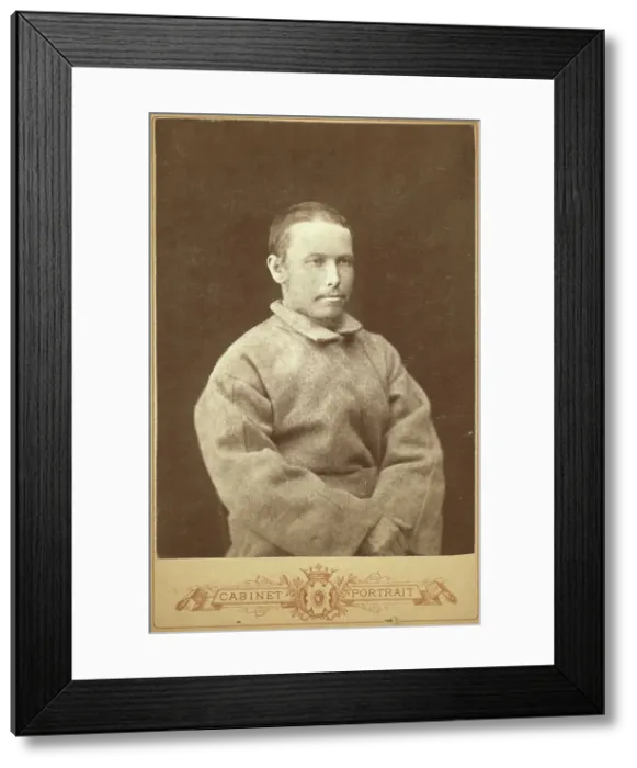 Framed Print : Half-length portrait of a man in convict coat, seated, facing right, between 1880 and 1886. Creator: Unknown Framed Print : Half-length portrait of a man in convict coat, seated, facing right, between 1880 and 1886. Creator: Unknown