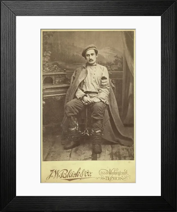 Framed Print : Full-length portrait of a man in convict clothing and leg irons, seated... between 1880 and 1886. Creator: Unknown Framed Print : Full-length portrait of a man in convict clothing and leg irons, seated... between 1880 and 1886. Creator: Unknown
