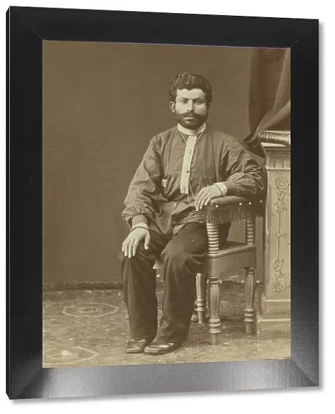 Full-length portrait of Armenian man, seated, facing front, between 1870 and 1886. Creator: Unknown