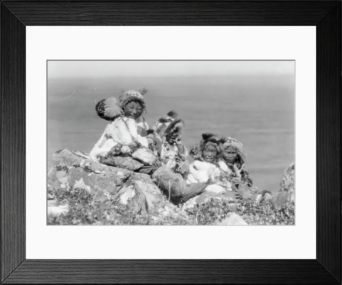 Framed Print : Four Eskimo children, at edge of cliff, in holiday costume, Nunivak, Alaska, c1929. Creator: Edward Sheriff Curtis Framed Print : Four Eskimo children, at edge of cliff, in holiday costume, Nunivak, Alaska, c1929. Creator: Edward Sheriff Curtis