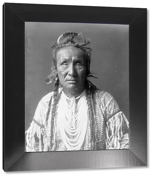 The Grizzly Bear, Piegan, half-length portrait, facing front, c1910. Creator: Edward Sheriff Curtis
