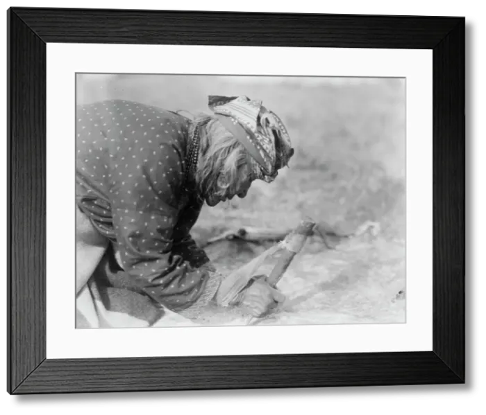 Framed Print : Blackfoot Indian fleshing a hide, c1927. Creator: Edward Sheriff Curtis Framed Print : Blackfoot Indian fleshing a hide, c1927. Creator: Edward Sheriff Curtis